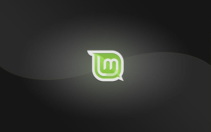 A Linux Mint logo over a black and gray swirled background.