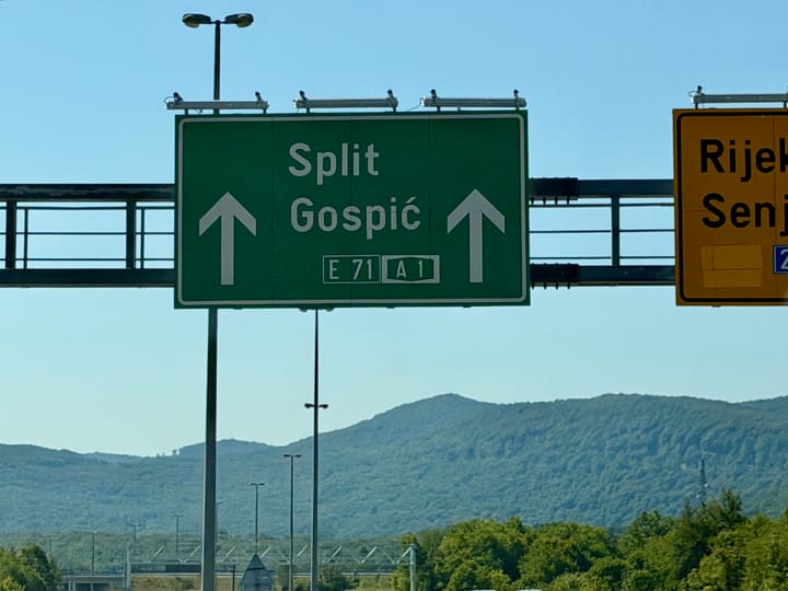 A road sign on Croatia's A1 Highway indicating to remain straight to proceed to Split / Gospić.